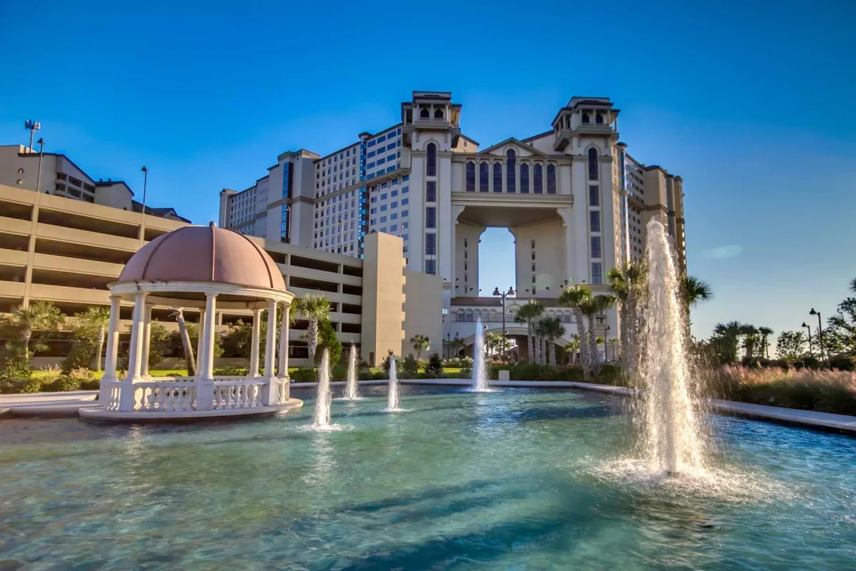 This image captures the elegant exterior of the resort, featuring a tranquil fountain, a charming gazebo, and the striking architecture of the hotel. The scene suggests serene walks around the water and moments of relaxation in the common areas, all set in an inviting, resort-style atmosphere.